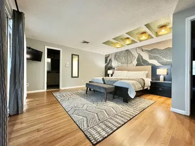a bedroom with a bed and a rug at 4 Rooms, Lake, Pool, Hot Tub, Putt-Putt in Orlando