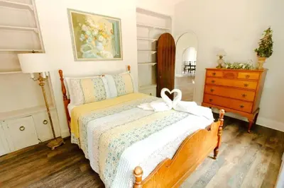 a bedroom with a bed with a bow on it at 6 Bedroom Historic Home in Orlando