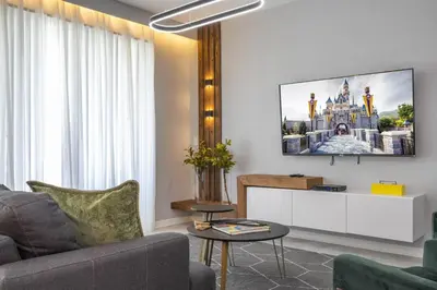 a living room with a couch and a tv on a wall at Storey Lake Resort 1250 - Hosted by Top Villas in Kissimmee