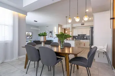 a kitchen and dining room with a wooden table and chairs at Storey Lake Resort 1250 - Hosted by Top Villas in Kissimmee