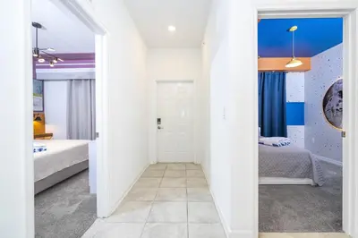 a room with two beds and a hallway at Storey Lake Resort 1250 - Hosted by Top Villas in Kissimmee