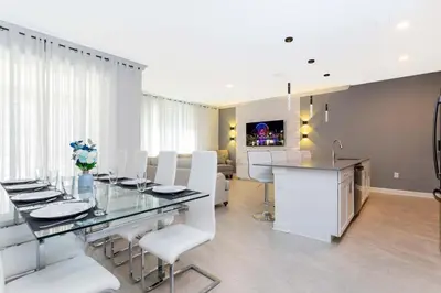 a dining room with a glass table and white chairs at Storey Lake Resort 363 - Hosted by Top Villas in Kissimmee