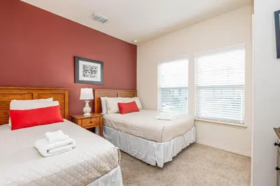 a bedroom with two beds and a window at Corner Villa in West Lucaya – Your Ideal Getaway in Kissimmee