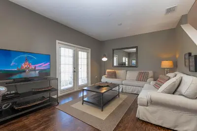 a living room with a large flat screen tv at Corner Villa in West Lucaya – Your Ideal Getaway in Kissimmee