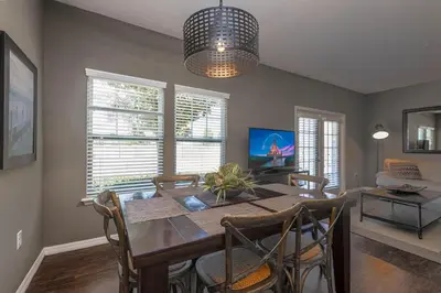 a dining room with a wooden table and chairs at Corner Villa in West Lucaya – Your Ideal Getaway in Kissimmee