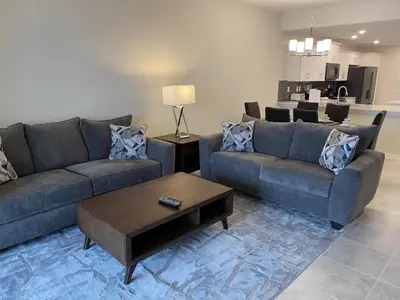a living room with two couches and a coffee table at Comfortable 2BR Condo w/ Lake Views in Kissimmee