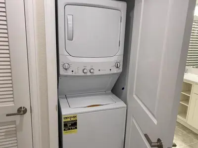a white washer and dryer in a small kitchen at Comfortable 2BR Condo w/ Lake Views in Kissimmee
