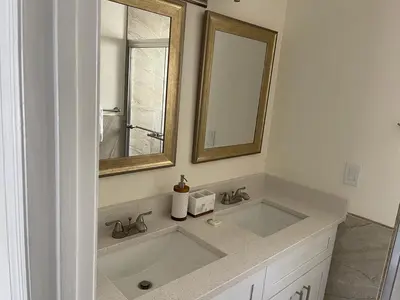a bathroom with a sink and a mirror at Grand Luxury 3BR Penthouse near Disney Parks in Kissimmee
