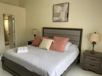 a bedroom with a bed with three pillows on it at Grand Luxury 3BR Penthouse near Disney Parks in Kissimmee