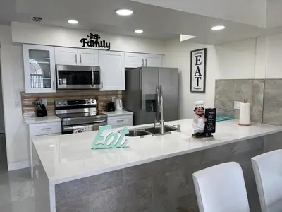 a kitchen with a large counter top in a kitchen at Grand Luxury 3BR Penthouse near Disney Parks in Kissimmee