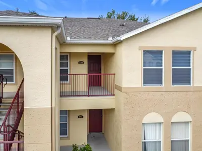 a house with a balcony and a staircase at The Galactic Getaway, 3Bed, 2Bath Apartment, Free Parking, Heated Pool in Kissimmee