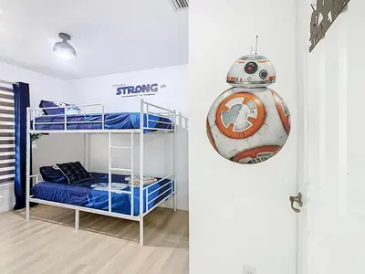 a room with two bunk beds and a star wars sign at The Galactic Getaway, 3Bed, 2Bath Apartment, Free Parking, Heated Pool in Kissimmee