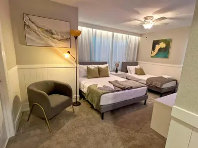 a bedroom with a bed and a couch and a chair at Spacious 5BR Villa w/ Private Pool Near Disney & Orlando! in Kissimmee