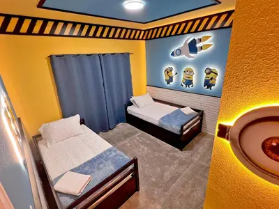 a small bedroom with two beds and a sink at Spacious 5BR Villa w/ Private Pool Near Disney & Orlando! in Kissimmee
