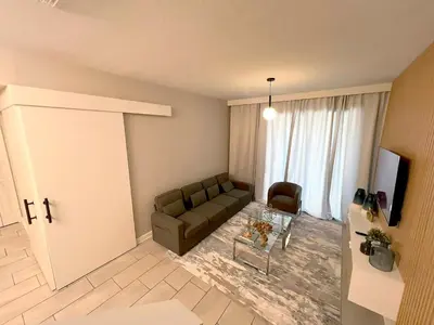 a living room with a couch and a television at Spacious 5BR Villa w/ Private Pool Near Disney & Orlando! in Kissimmee