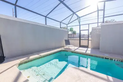 a swimming pool in a house with a glass roof at Spacious 5BR Villa w/ Private Pool Near Disney & Orlando! in Kissimmee
