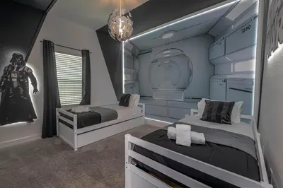 a bedroom with two beds and a captain america statue at Spacious 5BR Villa w/ Private Pool Near Disney & Orlando! in Kissimmee
