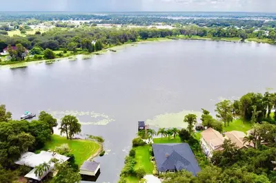 an aerial view of a large lake with houses at Large Deck, Lakefront, Yard Games in Orlando