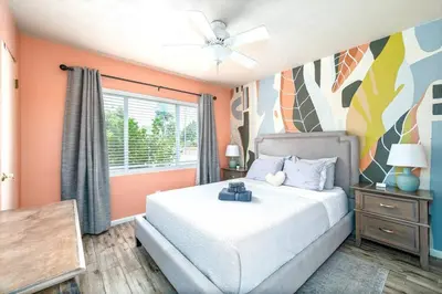 a bedroom with a white bed and a window at 4 Rooms, Lake, Pool, Hot Tub, Bocce Ball, Putting in Orlando
