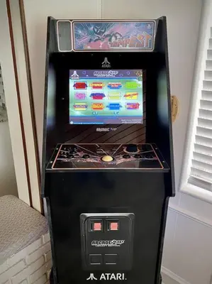 a video game machine with a screen on top of it at 4 Rooms, Lake, Pool, Hot Tub, Bocce Ball, Putting in Orlando