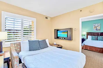 a bedroom with a bed and a couch and a tv at Suite with 2 Queens - Pool & Hot Tub in Orlando