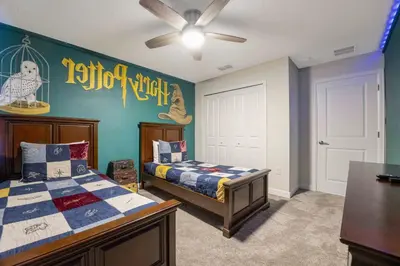 a bedroom with a bed and a wall with a sign on it at Stunning 4Bd Close to Disney with Pool at Storey Lake 4369 in Kissimmee