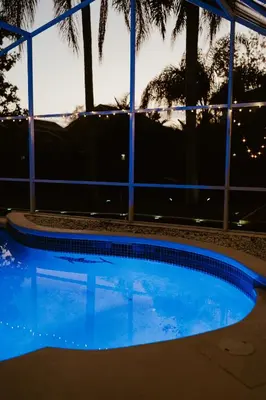 a swimming pool in front of a building at Luxury Private Pool Villa near Disney with Fire Pit, Game Room & More in Kissimmee