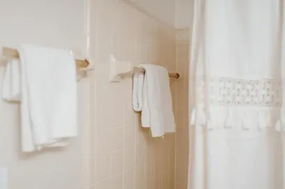 a bathroom with a shower with white towels at Luxury Private Pool Villa near Disney with Fire Pit, Game Room & More in Kissimmee