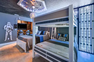 a bedroom with a bunk bed and a bedroom with a astronaut room at Private Pool and Game Room Family Vacation Rental in Kissimmee