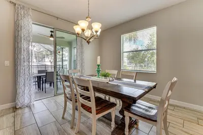 a dining room with a wooden table and chairs at Private Pool and Game Room Family Vacation Rental in Kissimmee