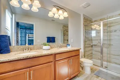 a bathroom with a shower and a sink and a toilet at Private Pool and Game Room Family Vacation Rental in Kissimmee