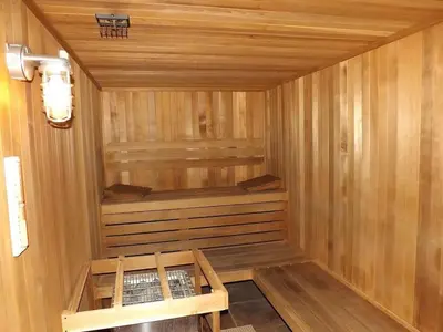 a wooden sauna with a bench in the middle at Vacation Home near Disney World! in Kissimmee