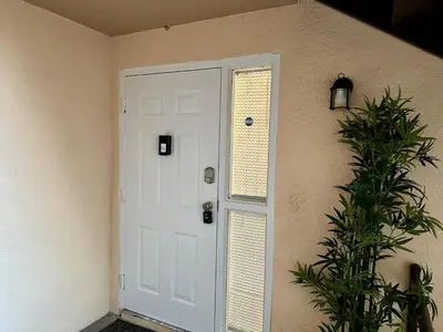 a white door in a room with a plant at Modern 2BR Lakeview Near Orlando Airport Free Parking in Orlando