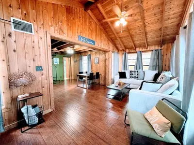 a living room with a couch and a table at Hook's Cabin- Lake & Pool Near Disney A-frame in Clermont