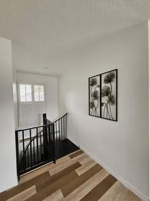 a white room with two pictures on the wall at Newly Renovated Modern Studio in Oviedo