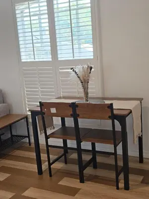 a wooden table with a chair and a window at Newly Renovated Modern Studio in Oviedo