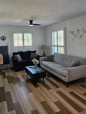 a living room with a couch and a table at Newly Renovated Modern Studio in Oviedo