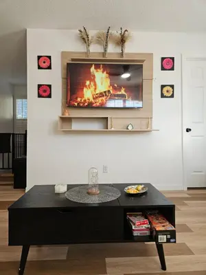 a living room with a fire in the wall at Newly Renovated Modern Studio in Oviedo