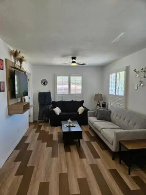 a living room with a couch and a table at Newly Renovated Modern Studio in Oviedo