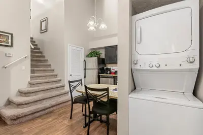 a kitchen and a dining room with a table at Tranquil Haven 2BD 2BA Paradise 10min to Orlando's Best Theme Parks in Orlando