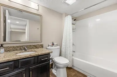 a bathroom with a toilet and a sink and a mirror at Tranquil Haven 2BD 2BA Paradise 10min to Orlando's Best Theme Parks in Orlando