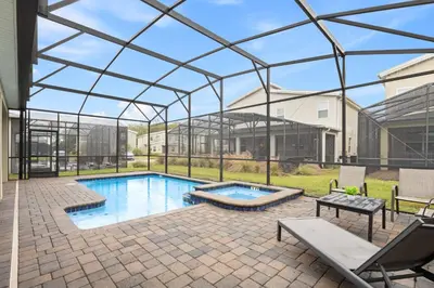 a swimming pool in a glass house at 4561 Majestic 9BD Kingdom Retreat Near Disney in Kissimmee