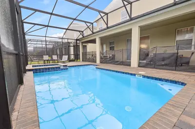 a large swimming pool with a glass ceiling at 4561 Majestic 9BD Kingdom Retreat Near Disney in Kissimmee