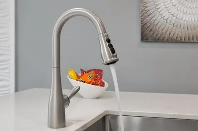 a kitchen sink with water running from a faucet at Storey Lake Home: Pool, Gym, Lazy River & near Disney in Kissimmee