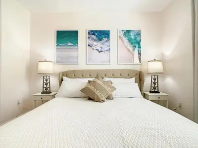 a bedroom with a bed with three pictures on the wall at Windsor Hills Luxury Condo, Pool,Slides, By Disney in Orlando