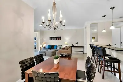 a dining room and living room with a table and chairs at Updated 3BR Condo near Convention Center & Epic in Orlando