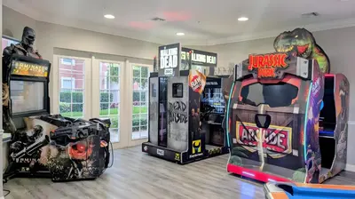 a room with arcade games and video games at 2BR Condo close Convention Center l Epic in Orlando