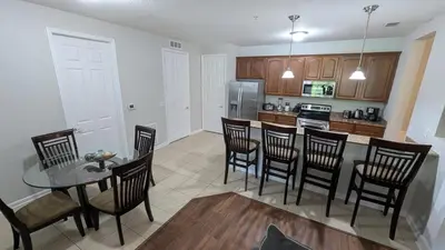 a kitchen with a table and chairs in a kitchen at 2BR Condo close Convention Center l Epic in Orlando