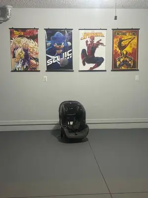 a helmet sitting on the floor next to posters on a wall at Family Dream Home Near Disney in Kissimmee