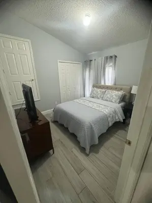 a bedroom with a bed and a television in it at Family Dream Home Near Disney in Kissimmee